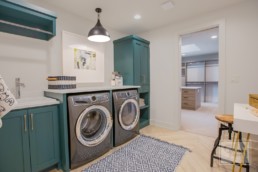 The modern laundry room with a connecting pantry in a Gordon James luxury lakeside mansion in Wayzata, Minnesota