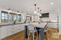 Picturesque country styled kitchen of a Gordon James' luxury home offers a view of Shaver's Lake in Wayzata, Minnesota