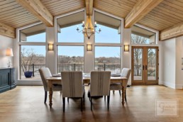 This open concept dining room features a view of the gorgeous Shaver's Lake in a custom-built Gordon James residence in Wayzata, Minnesota