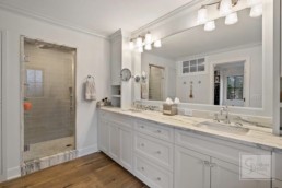 dual sink bathroom with a shower in a luxury custom built by Gordon James in Wayzata, Minnesota
