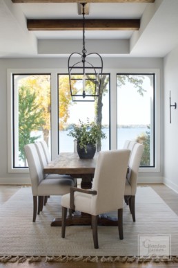 The dining room of a luxury modern lakeside home in Casco Point, Minnesota custom designed by Gordon James Construction