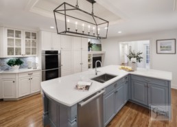 Luxury home kitchen features blue slate cabinetry and white marble countertops by Gordon James.