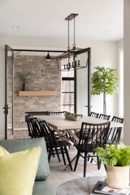 A farmhouse inspired dining room in a custom Haus of Rowe Interiors designed Gordon James luxury home in Minnetrista, Minnesota blends luxury and functionality.