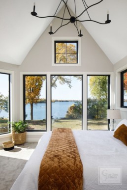 A bedroom of a luxury modern lakeside home in Casco Point, Minnesota custom designed by Gordon James Construction