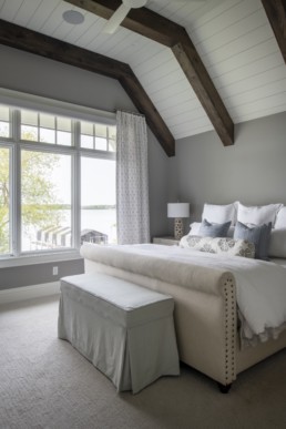 A bedroom of a Gordon James luxury lakeside home with a view of Crystal Bay in Minnetonka, Minnesota.