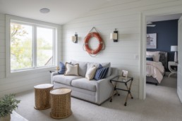 A nautical themed sitting area in a Gordon James luxury lakeside home in Crystal Bay in Minnetonka, Minnesota at dusk.