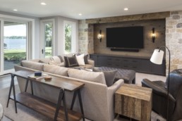 A living room in a Gordon James custom luxury home features the ultimate home theatre experience.